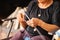 Ageless artistry. Elderly woman weaves yarn with skill