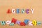 AGENCY word on wooden background composed from colorful abc alphabet block wooden letters, copy space for ad text. Learning