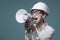 Aggressive businesswoman shouting through a megaphone