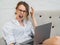 Aggressive career woman works at home. Screaming and frustrated woman with laptop