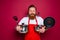 aggressive chef with beard and red apron is ready to cook