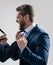 Aggressive man in suit scream fist fighting with colleague grey background, physical assault