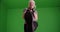 Aggressive mature woman shadowboxing on greenscreen