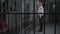 Aggressive prison employee watches criminals in prison cells