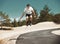 Aggressive riding. A young athlete performs a roller skate jump.