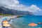 AGIA ROUMELLI, CRETE - 20 JULY 2021: Tourists relaxing on the rocky beach in the village of Agia Roumelli near the exit of the