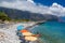 AGIA ROUMELLI, CRETE - 20 JULY 2021: Tourists relaxing on the rocky beach in the village of Agia Roumelli near the exit of the