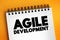 Agile Development - any development process that is aligned with the concepts of the agile manifesto, text concept on notepad