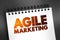 Agile Marketing - approach to marketing that utilizes the principles and practices of agile methodologies, text concept on notepad