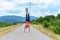 Agile woman doing a handstand on a rural road