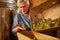 Aging winery worker holding a cluster of white grapes