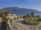 Agios Georgios Pagon sand beach onCorfu island, Greece viewed from promenade with flower pots, with sun beds, swimming peoples and