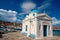 Agios Nikolaos church in Mykonos, Greece. Temple building with blue dome on sea quay. Church on sunny seaside. Summer