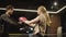 Agitated sport woman practicing leg hits on boxing ring. Fit girl boxing at gym