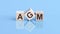 AGM is an abbreviation of the Annual General Meeting - the text is written on wooden cubes