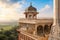 Agra Fort white marble medieval palace architecture at sunrise with view of Taj Mahal and scenic landscape at Agra India