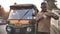 Agra, India - December 12, 2018: Indian auto rickshaw tut-tuk driver man recounts money.