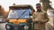 Agra, India - December 12, 2018: Indian auto rickshaw tut-tuk driver man recounts money.