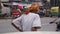 Agra, India, February 2020. A poor old Indian man is walking along the street and road.