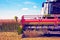 Agrarian industrial landscape with aggregates of a combine close-up, which collects a harvest on a field in a sunny day.