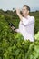 Agrarian man in vineyard tasting wine