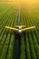 An agricultural aircraft plane watering a field during the daytime