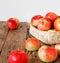 Agricultural apple background. Red early ripe apples on a wooden background