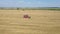 Agricultural Combines Harvest Ripe Wheat Crops On Rural Field Aerial Side View