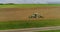 Agricultural concept. The tractor is working on the harvest field. The moving copter back. Beautiful panorama of