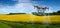 agricultural drone sprays rapeseed fields to protect against pests