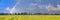 Agricultural field on horizon under the sky after the rain with colorful rainbow, panorama, banner