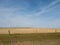 Agricultural Field in Montana with Hay Bales and Wind Turbines