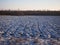 Agricultural field under the first snow. The clods of earth, field, plowed