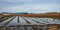 Agricultural fields filled with rain water. Tire tracks of agricultural machinery filled with puddles on a muddy field