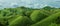 Agricultural Green corn field on hill with blue sky