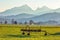 Agricultural implements, rural outdoor background, mountains in the background