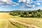 Agricultural landscape in the Czech Republic. Grain harvest. Mown field. Straw in the field. Summer day on the farm