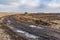 Agricultural landscape earth road on harvested maize field