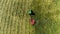 Agricultural machine harvests wheat. Agriculture. The tractor rides in the field.Aerial view. From above.