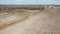 Agricultural machinery in a field near a small grove, aerial view. Agricultural land.