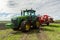 Agricultural machinery, Tractor and farmer in agricultural fields of wheat and rapeseed