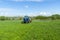 Agricultural machinery, Tractor and farmer in agricultural fields of wheat and rapeseed