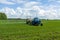 Agricultural machinery, Tractor and farmer in agricultural fields of wheat and rapeseed