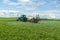 Agricultural machinery, Tractor and farmer in agricultural fields of wheat and rapeseed