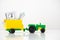 Agricultural machinery on a white background. green tractor with a yellow trailer. time to invest in organic food. use as