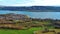 Agricultural meadows, spring forests and a small village on the banks of the river Rhine with hills in the background