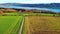 Agricultural meadows, spring forests and a small village on the banks of the river Rhine with hills in the background