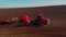 Agricultural modern tractor plough plows ground before planting the crop, preparing soil for sowing, view from the drone