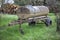 Agricultural old rusty trailer with a water tank on it