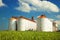 Agricultural silos under blue sky, in the fields